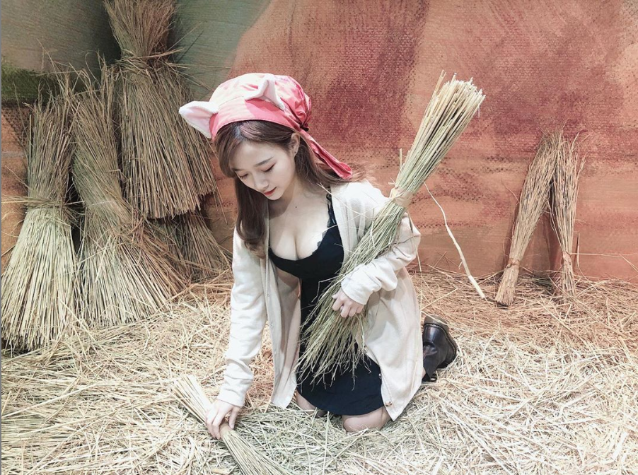 The hot girl sitting on a haystack