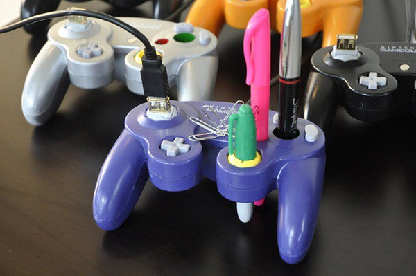 A broken game controller repurposed into a convenient pen holder that also serves as a charger.