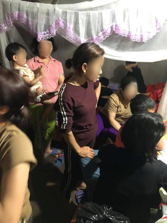 Image of family members gathered around the boy studying.