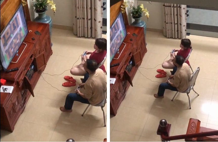 Two parents engrossed in the 4-button console they just commandeered from their son