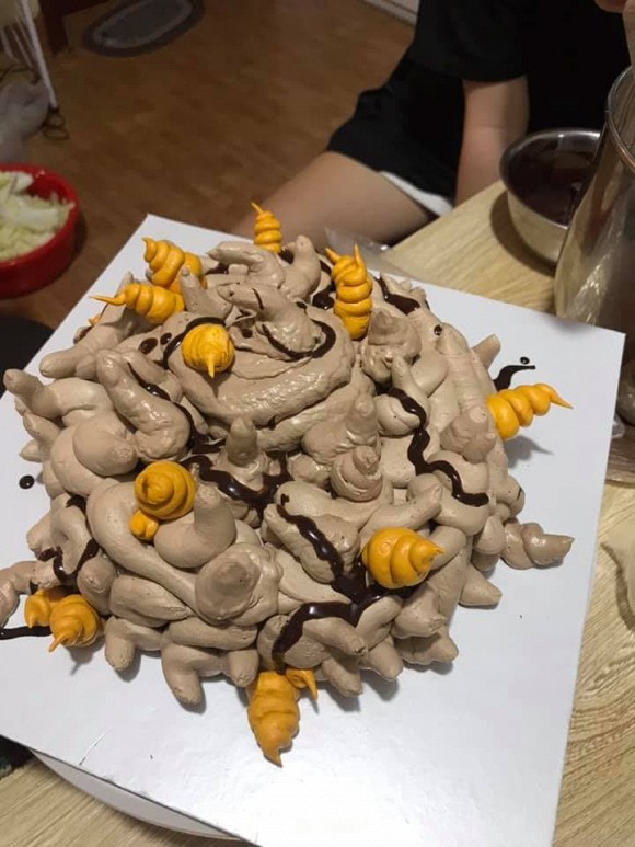 A birthday cake with a super chaotic layout, making one think of extremely unsanitary things.