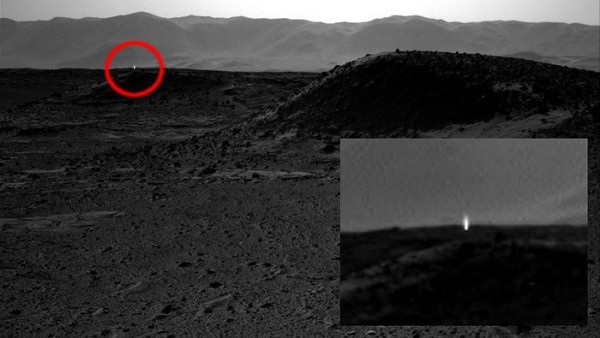 NASA's Curiosity rover captured a strange bright spot in the distance of the mountain range, which scientists later confirmed to be merely cosmic rays revealing themselves.
