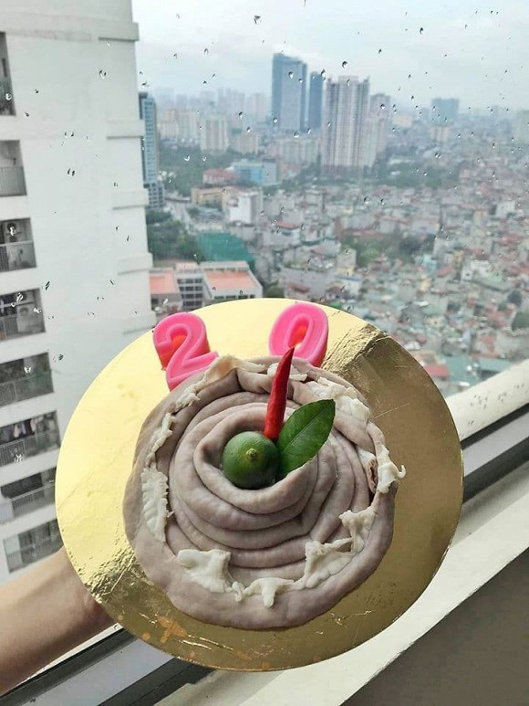 Another birthday cake arranged quite oddly, resembling savory food instead.