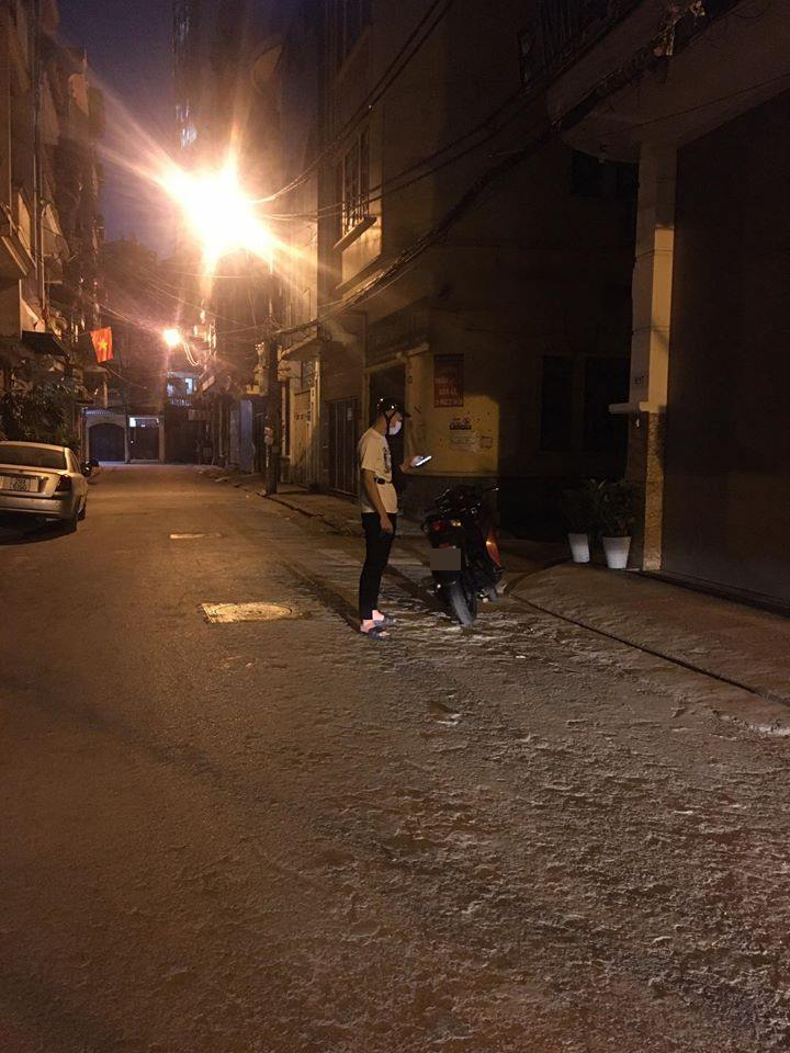 The main character standing in front of his girlfriend's house