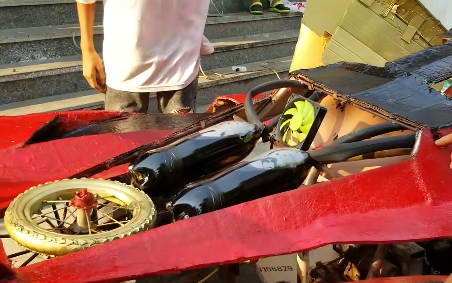Two soft drink bottles attached to 'simulate' the Ferrari engine