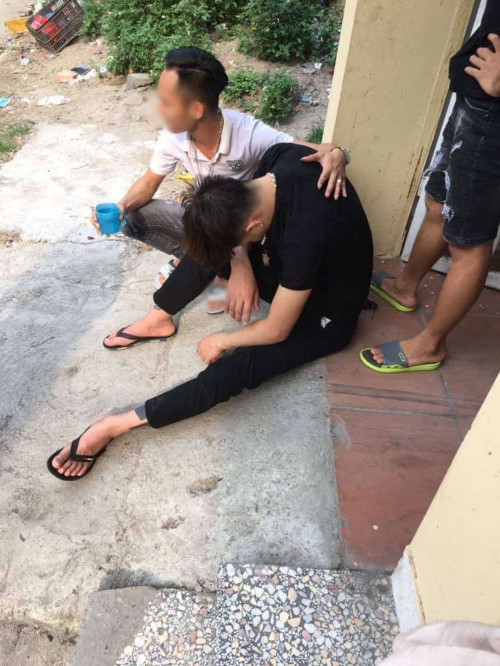 Image of the young man being comforted by others after the seemingly overwhelming shock