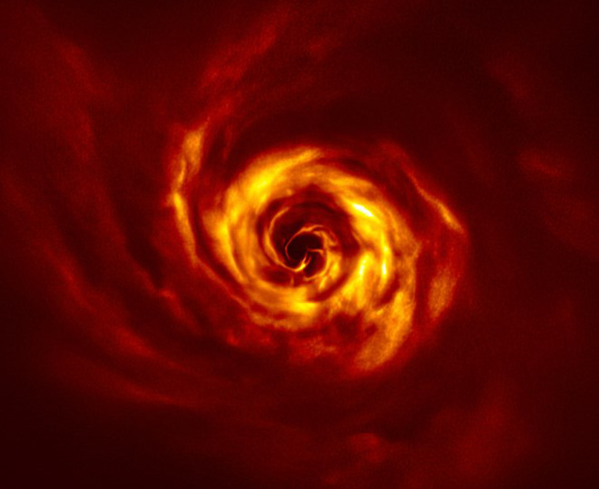 Spiral structure appearing inside a dense disk of dust and gas surrounding the star AB Aurigae.
