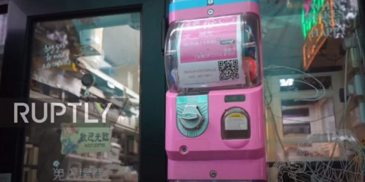 The machine with a pink exterior is located outside a pet shop to help singles find their match.