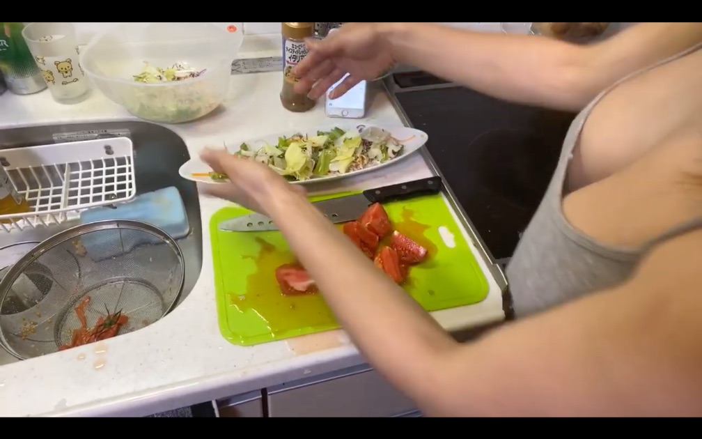 As a way to highlight the sensuality of her curves rather than the salad she is making