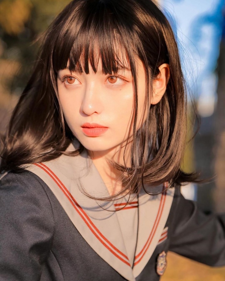 The charming face with a high nose and expressive big eyes of the hot girl