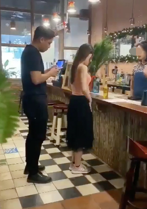 Image of the girl looking flustered while paying at the cafe