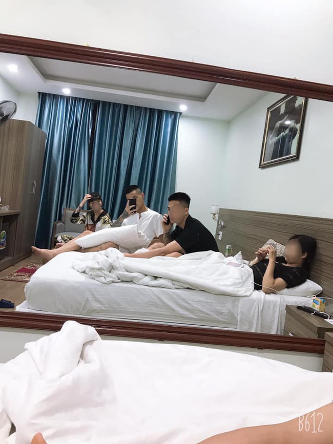 D.H and a group of friends resting in a hotel room.