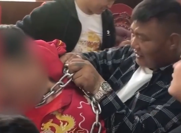 The groom's friends trying to rescue him but helpless due to the lost key