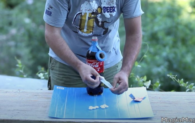 Scene of Milleaccendini with tools like Mentos, a condom, and a bottle of Coca-Cola