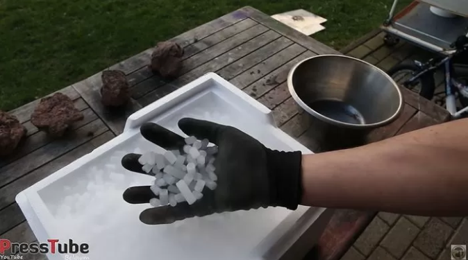 As soon as the dry ice box is opened, white steam emerges, and the YouTuber must wear specialized gloves