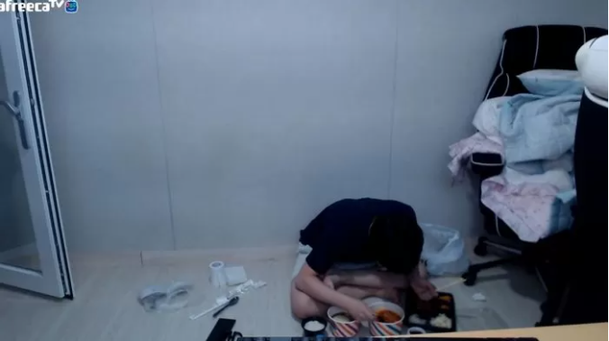 A somewhat pitiful image of the YouTuber eating