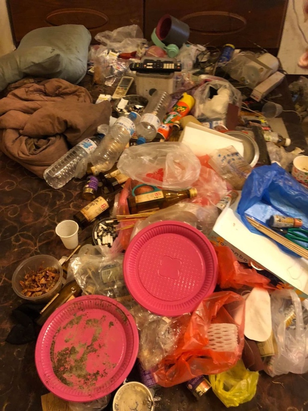 A bed covered in trash but still has someone who can lie on it every day.