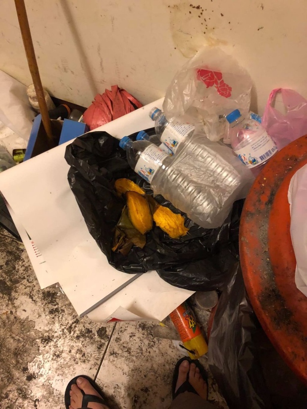 Mango seed and a bottle of mineral water discarded in a corner of the room after use.