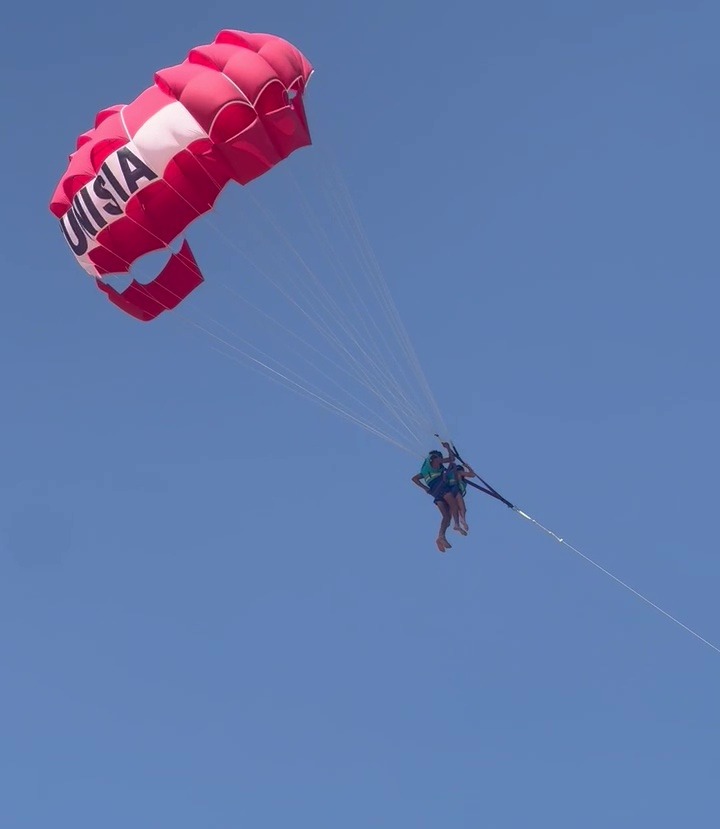 Michelle paragliding with a young Tunisian operator